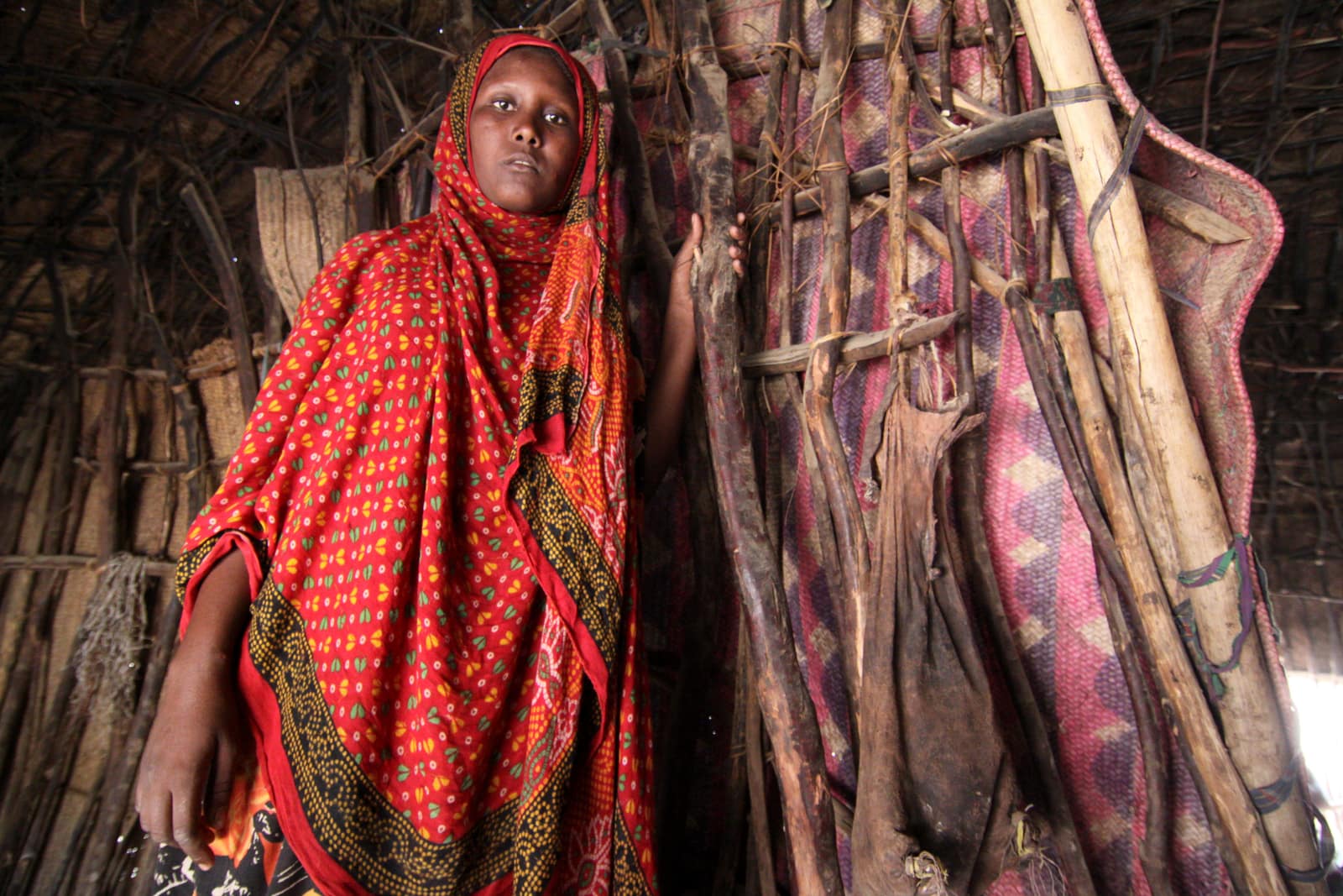 Young Afar woman in a bright red headscarf in northern Ethiopia