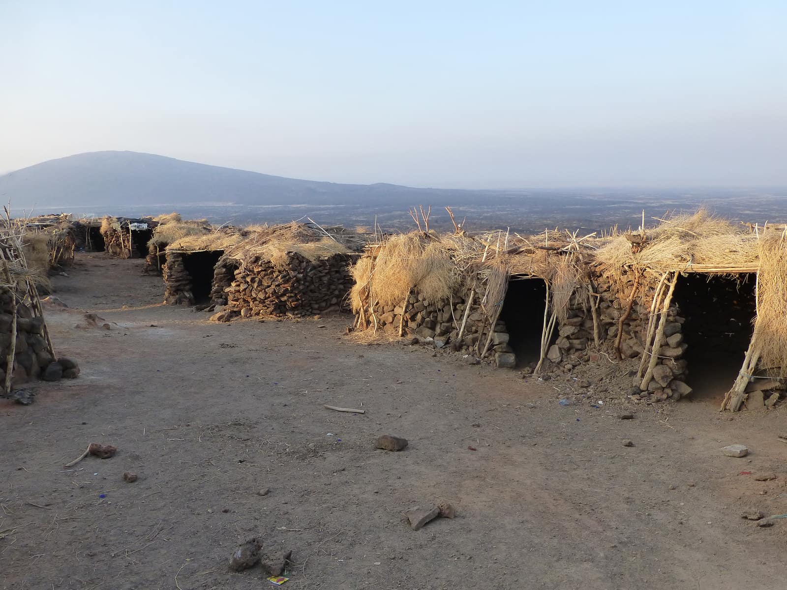 Stone shelters at a desert camp near Erta Ale in the Danakil Depression